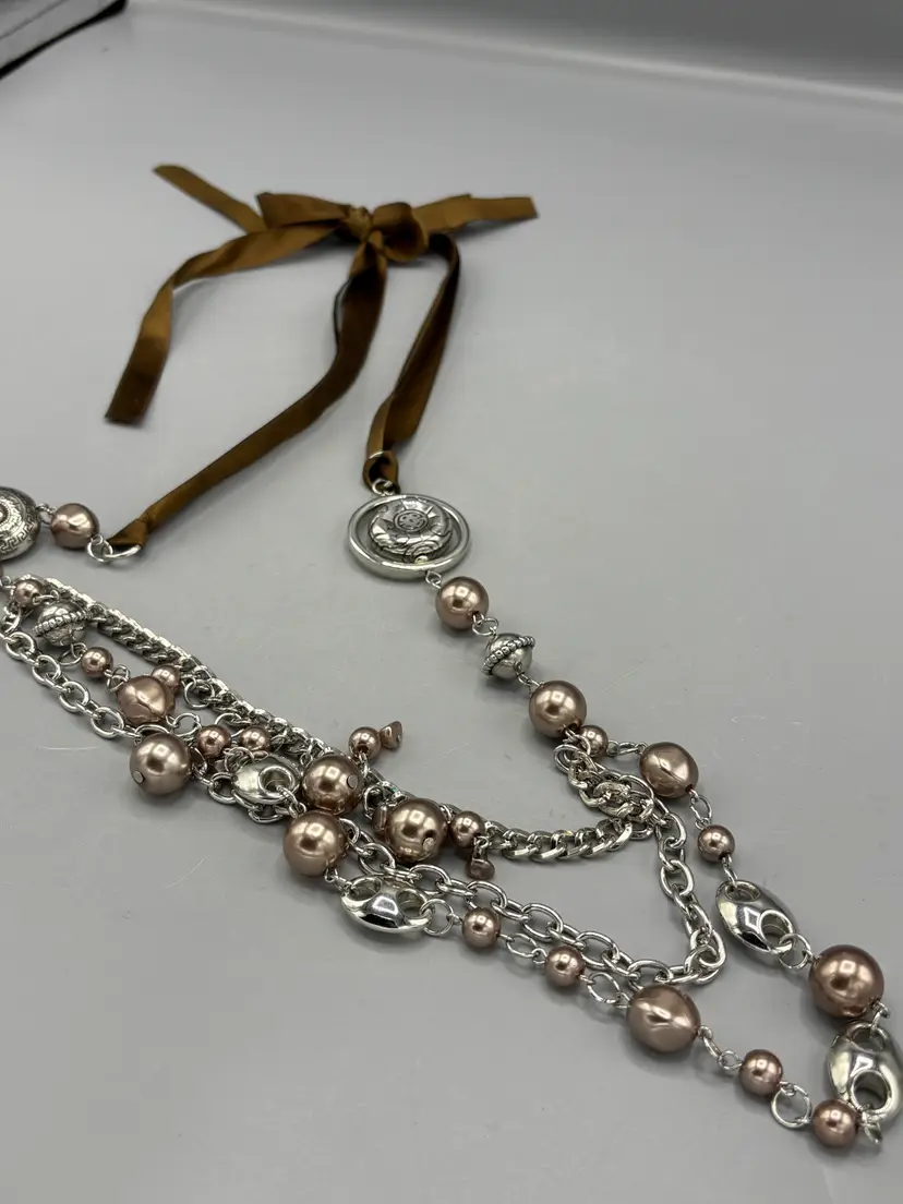 Silver beads with brown ribbon