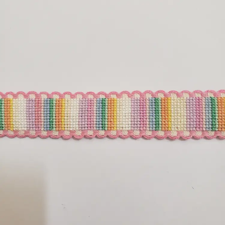 New Cross-stitched multi colored striped Ribband with pink trim.