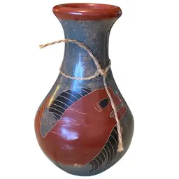 handcrafted folk art pottery, likely from Mexico or Nicaragua, featuring painted fish or aquatic designs. Vase