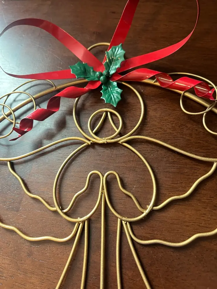 Gold-toned wire angel wreath Christmas card holder with red ribbon. 13”