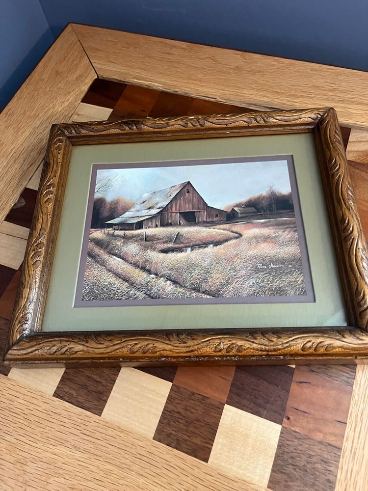 Wood framed and matted print by the artist Ruane Manning, depicting a rural scene with a barn.
