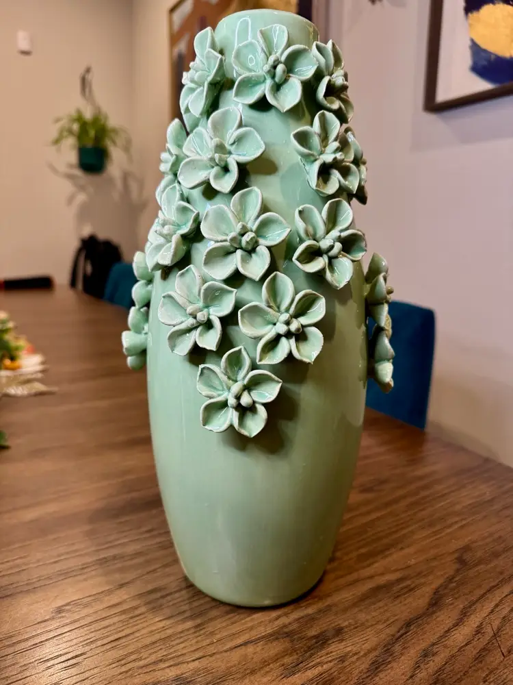 Gorgeous light green ceramic vase with hand applied, sculpted flowers.