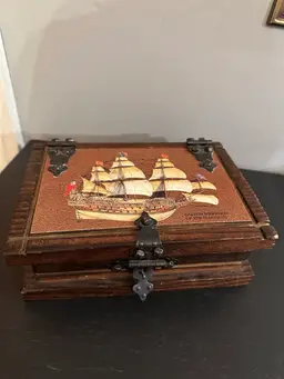 This is a vintage Nautical wooden box with A Picture of a Ship.