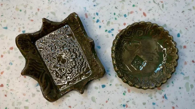 #01 Set of handmade studio pottery forest/mossy green trinket or ring dishes. 3” x 2  5/8” rectangle and 2 7/8” round. Approximately 3/4” tall.  Both are signed by artist.