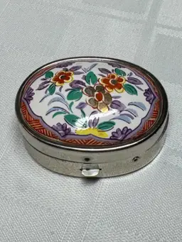 Vintage hand-painted enamel floral trinket box with metal casing
