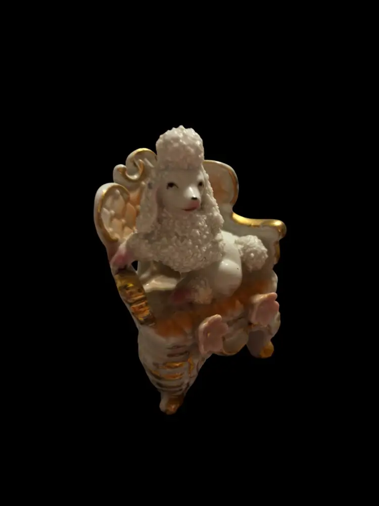 White Porcelain Spaghetti Poodle Figurine Sitting On An Elegant Gold Trimmed Chair