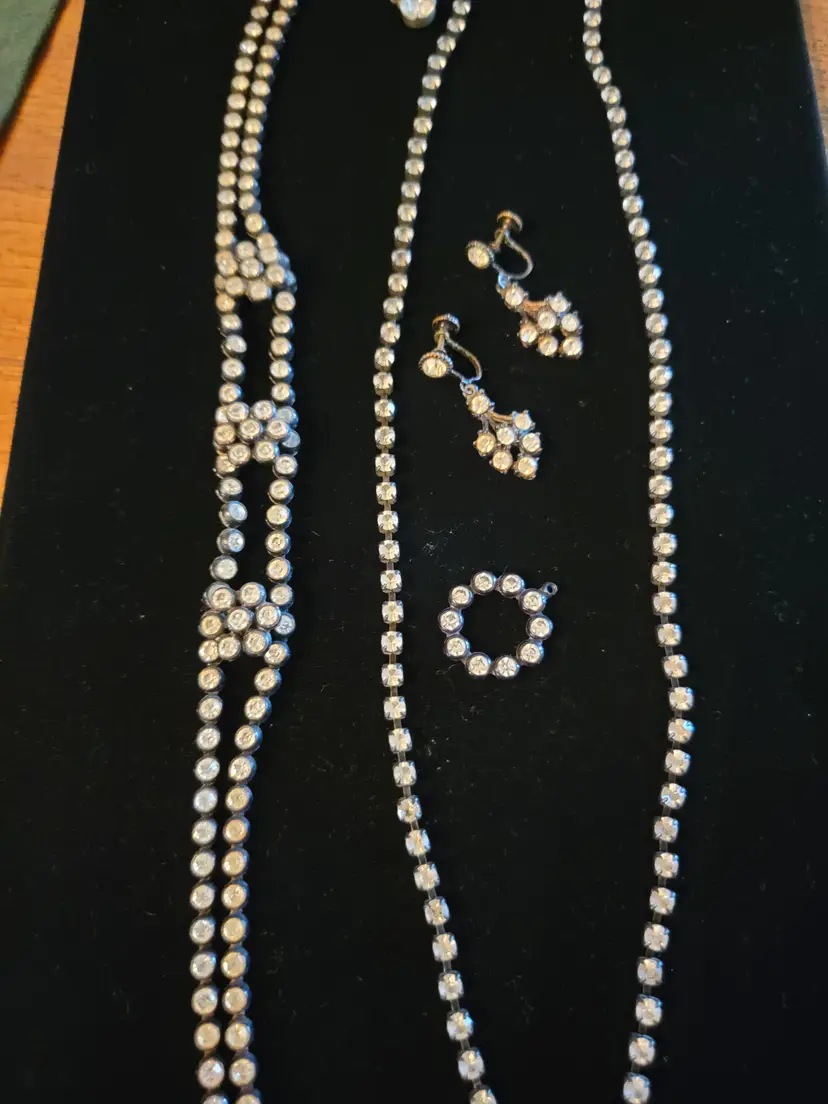 Two vintage rhinestone necklaces with black metal and plastic chains. Matching drop screw-back earrings