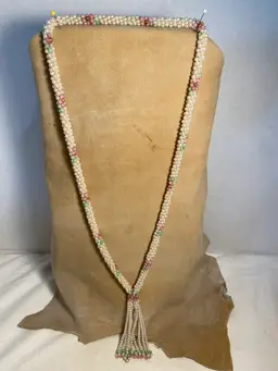 1970’s long slip over pearl necklace with pink green and gold designs