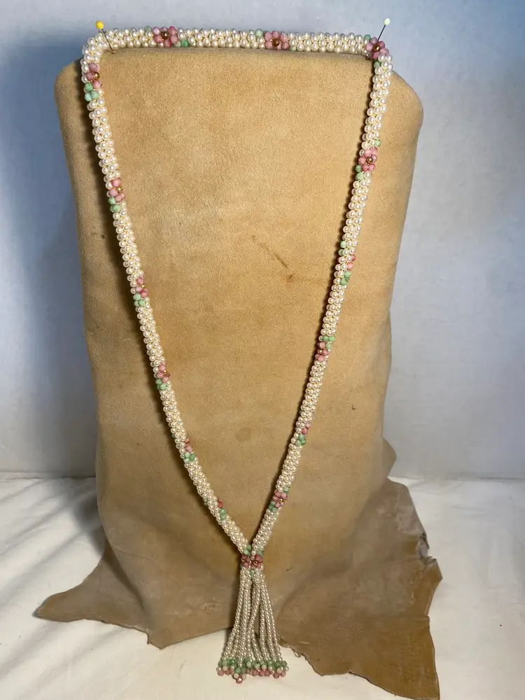 1970’s long slip over pearl necklace with pink green and gold designs