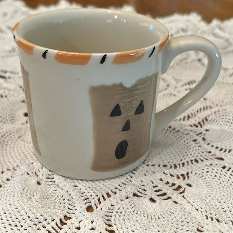 Vintage Starbucks Barista Hartstone Halloween mug. The mug is 14 oz and features a hand-painted design of paper bag jack-o'-lanterns with a candy corn striped rim. The mug is made of heavy ceramic and was produced exclusively for Starbucks in the USA.