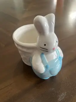 A vintage ceramic bunny planter with blue overalls. 3.5x4”