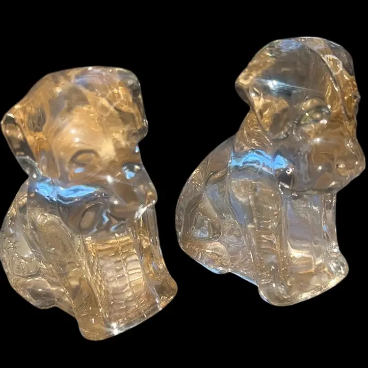 Two light pink glass, hollow dog figurines 3 inches tall has a unique pinkish tent to the glass and some glow with UV light