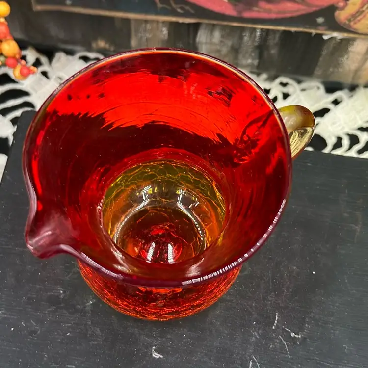 This is a vintage Amberina crackle glass 3.5” Creamer/pitcher With Applied Handle, Cadmium Glow!