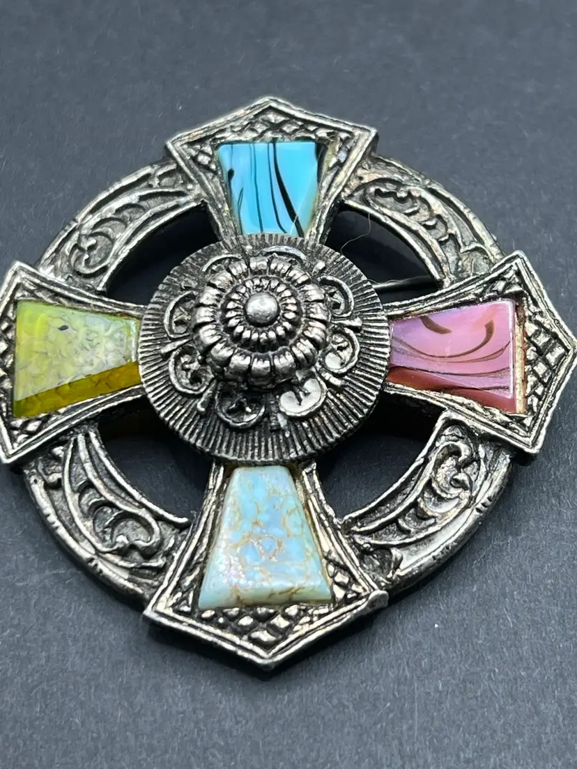 Vintage Miracle Celtic cross brooch with inlaid colored glass segments.
