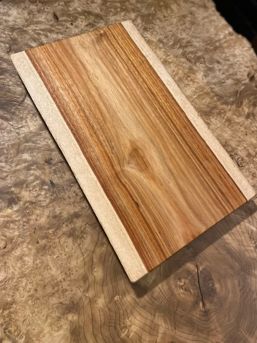 Live edge Canarywood cutting board with integrated plate slide handles