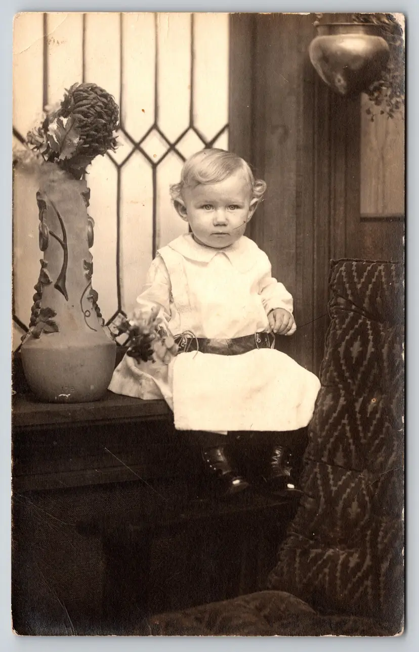 Postcard RPPC Cute Curly Haired Baby Sitting on Desk Real Photo Children - 9347