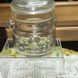 Vintage Atlas E-Z Seal 1/2 pint clear glass mason canning jar with a wire bail.