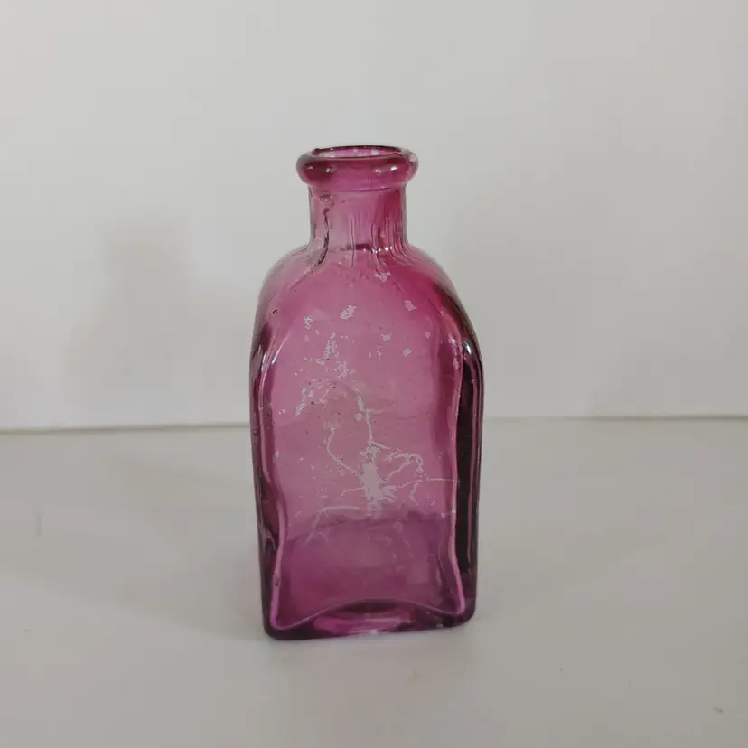 Small purple bud vase. Some missing color. 4 inches high.