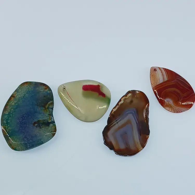 Four Polished Gemstone Pendants