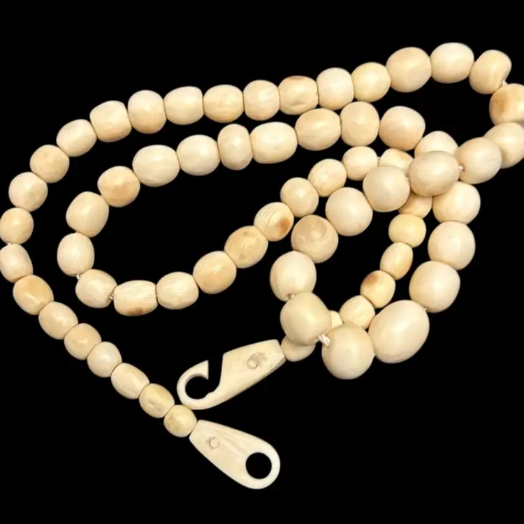 vintage carved bone or ox bone graduated bead necklace with a carved screw clasp
