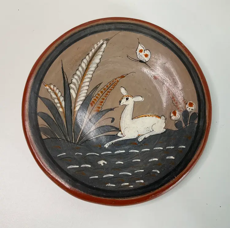 Handmade pottery plate 6” round with deer, butterfly, and flowers painted on it. Made in Mexico