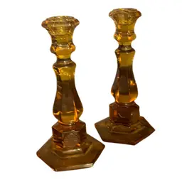 A pair of Fostoria amber coin glass candlesticks.8” 1956-1986
