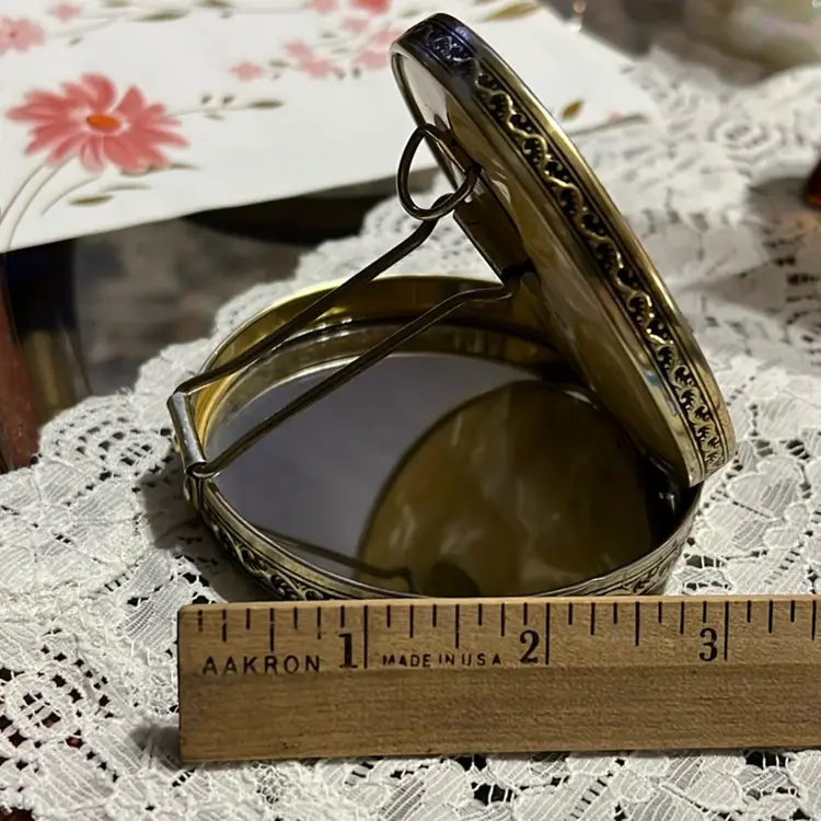 Vintage Round Mother Of Pearl Designed celluloid compact mirror with decorative metal trim. Circa 1940