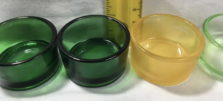 5 glass tea light candle holders, 4 green, 1 yellow, 1" x 2" diameter