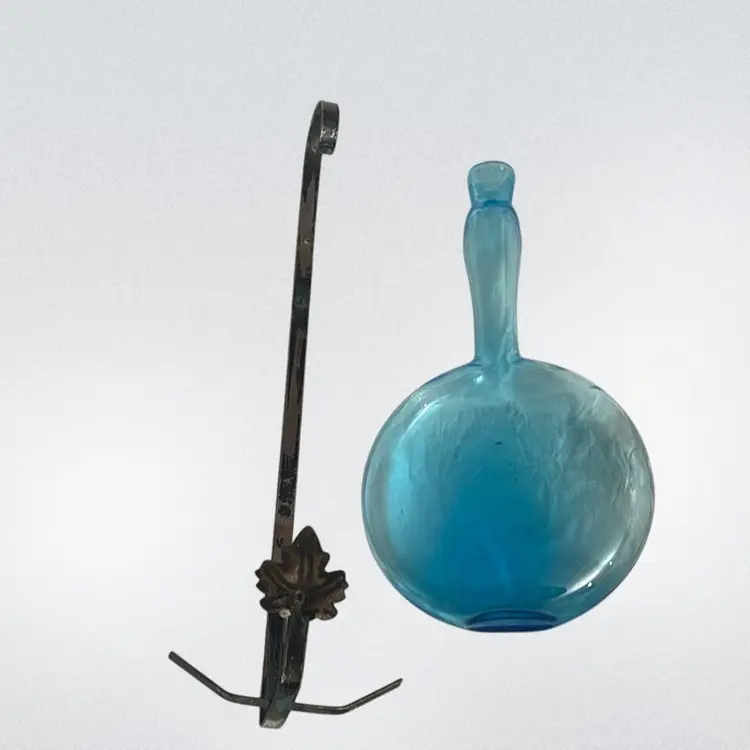 Blue Glass Bottle In Metal Holder