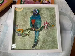 Quilled Exotic bird sitting on a vine. The Head is a blown glass pendant.