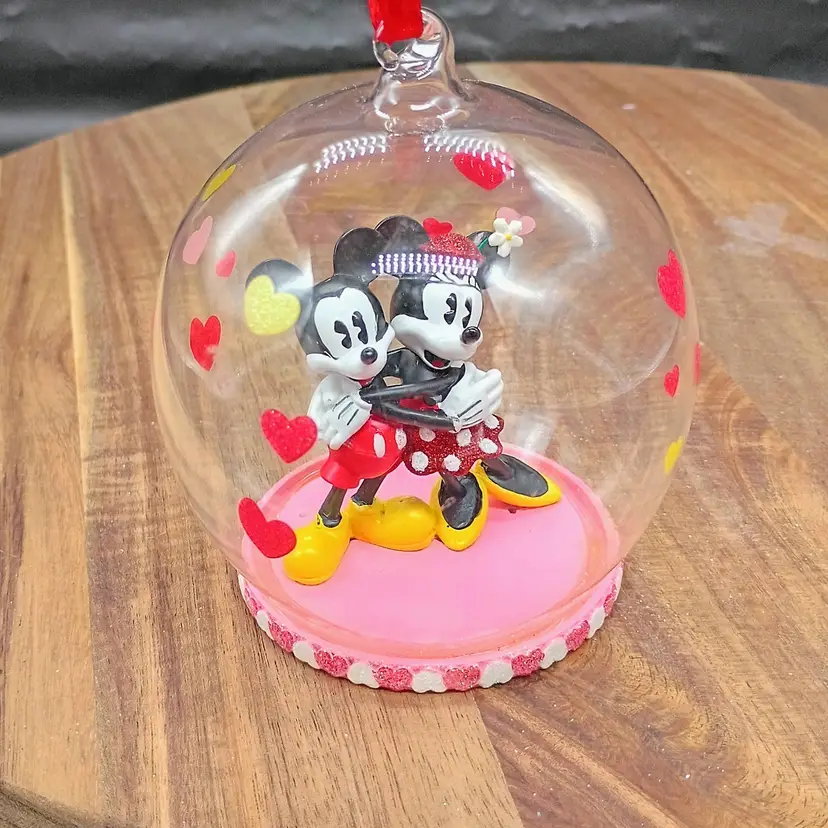 Disney Sketchbook Collection Sweethearts Micky & Minnie Mouse Blown Glass Cloche Ornament. Dated 2018. This is 4 inches tall and 3.5 inches in diameter. This is preowned, Mickey and Minnie are secure on base. No damage to glass, Hanging ribbon intact, has date tag. Painted Hearts intact. Excellent condition. No original box. Ships USPS