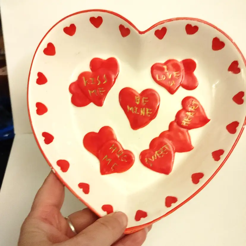 Heart shaped dish with conversation hearts. Some paint loss on rim. 7x7.