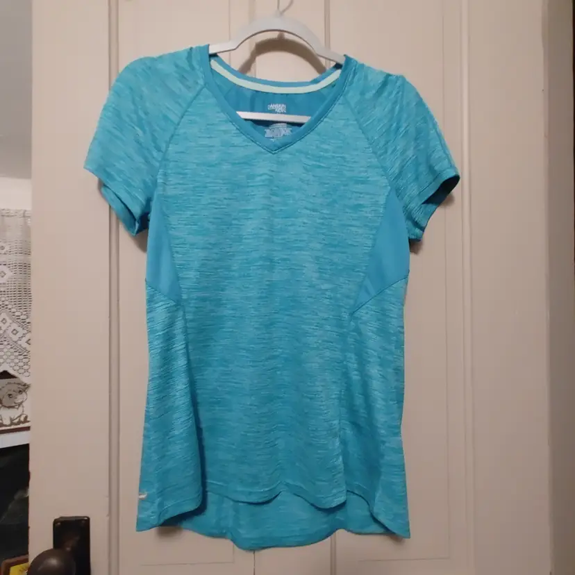 Top- Brand: Danskin now. Size Medium 8-10. Teal top. Material- 100% polyester. No callouts.