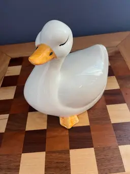 #01 A vintage glossy white ceramic duck figurine with orange beak and feet. 1970-1980
7.5 “ High By 8 “ Long
Does have small chip on tail feathers