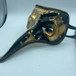 Black and gold Mardi Gras mask approximately 10 1/2 inches long