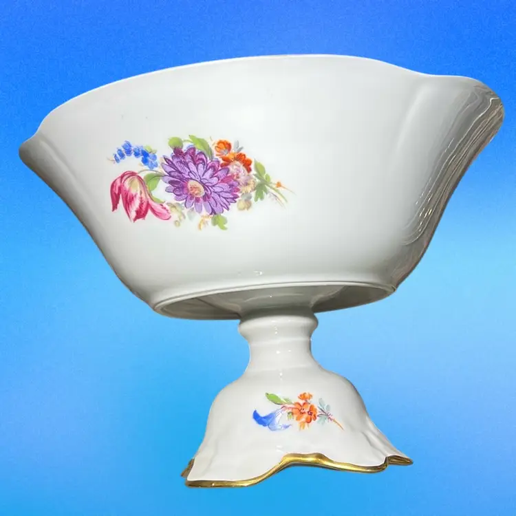 Antique Limoges porcelain compote with hand-painted floral motifs and gilt rim.