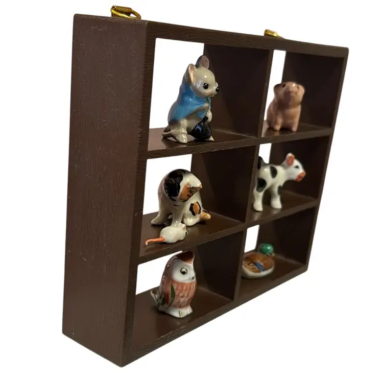 small, dark hard plastic wood trinket display shelf 6” L, 5” H & 1.5 W.