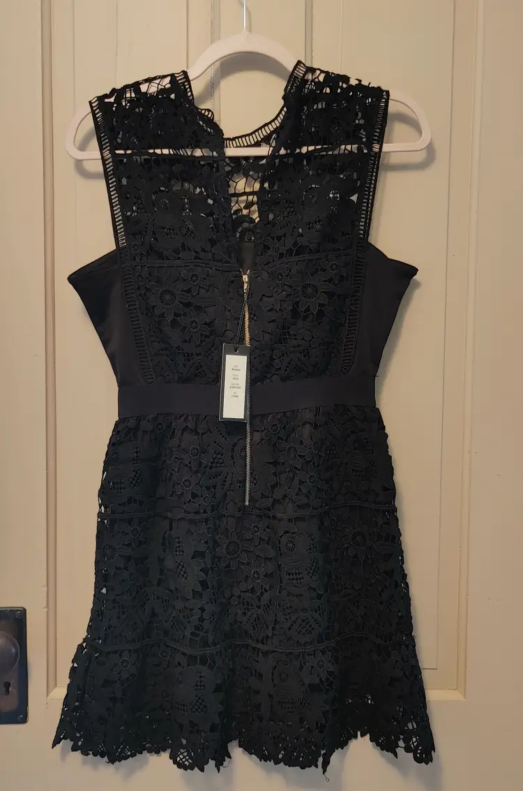Dress- Brand: Romeo & Juliet Couture. Size Medium. NWT. Black lace dress. Material- 100% polyester. No callouts.