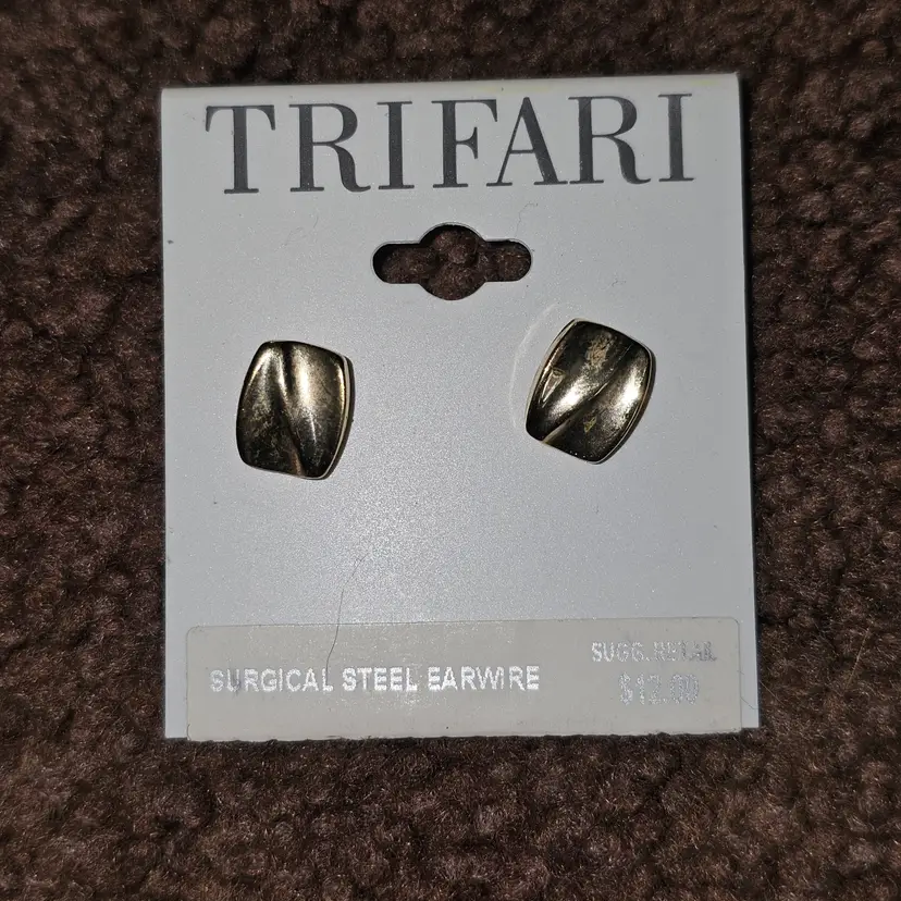 New old stock Trifari pierced gold tone surgical steel earrings on card