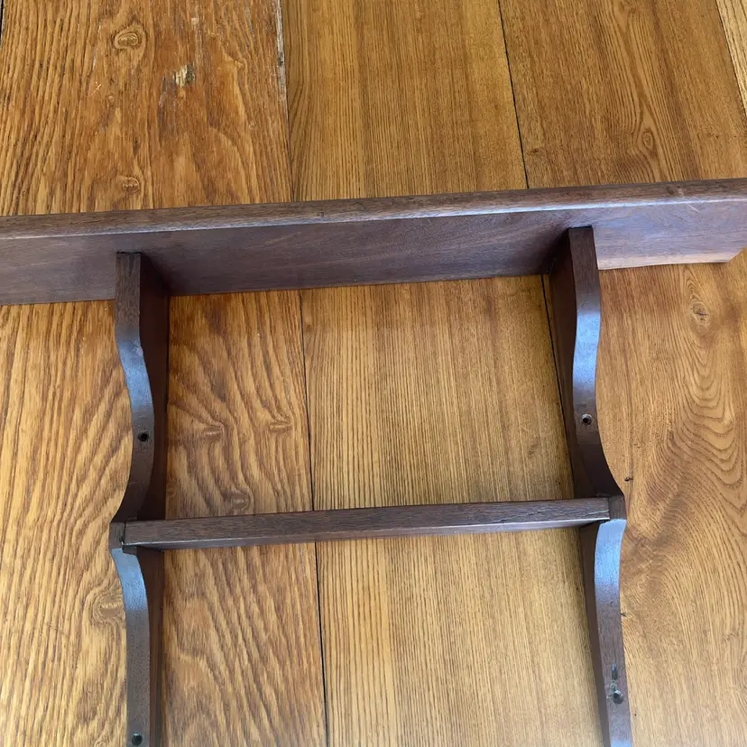 30” A dark-stained wooden wall shelf with a lower rack (15”) and brackets.