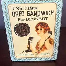 1986 collectible tin featuring a reproduction of an early Oreo advertisement From 1918.
8.5“ X 6“ X 2.5”