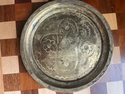 A vintage etched brass decorative tray with floral motifs. - 9”