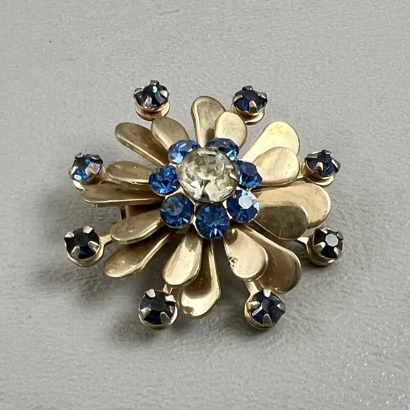 Vintage Gold Tone Flower Brooch Blue Rhinestone Clear Center Starburst Mid Century 1.25"