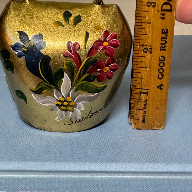Hand-painted Swiss cowbell featuring alpine flowers and "Switzerland"