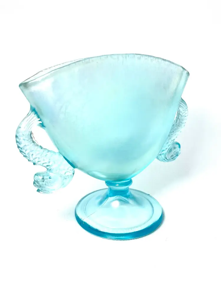 5-1/2” Fenton Aquamarine Blue Footed Double Handled Fan Vase. Dolphin 🐬 Shaped Glass Handles. Stunning Iridescent Sheen. Green-Yellow Glow Under UV Light. Art Nouveau Vibes.