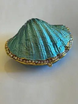 Beautiful Blue Enameled Metal Shell Shaped Trinket Box.  Top Is Surrounded By Sparkly Crystals Open It Up And You Find Your Pearl. Magnetic Closure This Is An Excellent Condition.