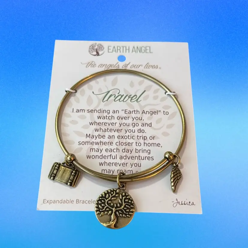 #24 NOC Earth Angel Travel Bracelet On Gift Card Goldtone Metal 2.5” Expandable Band 
Charms Include Tree Of Life, Angel Wing, Luggage Excellent Condition UNTESTED