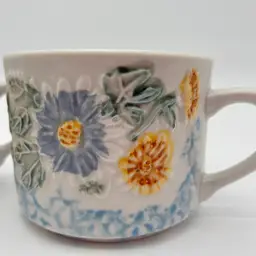 Daisy Patch Tabletops Unlimited 2 Floral Embossed Ceramic Mugs Blue Yellow White