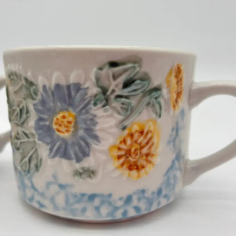 Daisy Patch Tabletops Unlimited 2 Floral Embossed Ceramic Mugs Blue Yellow White