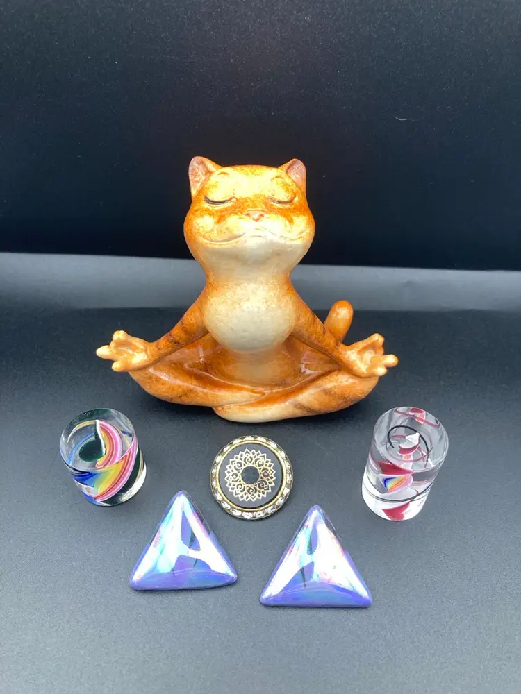 Meditating Meow Vignette! Meditating Kitty (4 1/4” Tall 4 1/4” Wide) Miniature Glass Rainbow Swirl Paperweight (1” Tall 1” Wide) Miniature Glass Spiral Paperweight (1 1/2” Tall 1” Wide) Pierced Earrings (1 1/4”) Single Rhinestone Clip On Earring (1” Diameter)